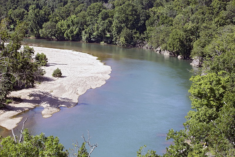 FILE - The Illinois River as seen from Goat's Bluffat the J.T. Nickel Family Nature and Wildlife Preserve in Cherokee County, Okla., July 18, 2019. A federal judge is giving Oklahoma and nearly a dozen poultry companies, including the world’s largest poultry producer, Tyson Foods, an additional 90 days to reach an agreement on plans to clean a watershed polluted by chicken litter. U.S. District Judge Gregory Frizzell on Friday, March 17, 2023 scheduled a June 16 hearing in Tulsa, saying both sides requested the extension. (Mike Simons/Tulsa World via AP, File)