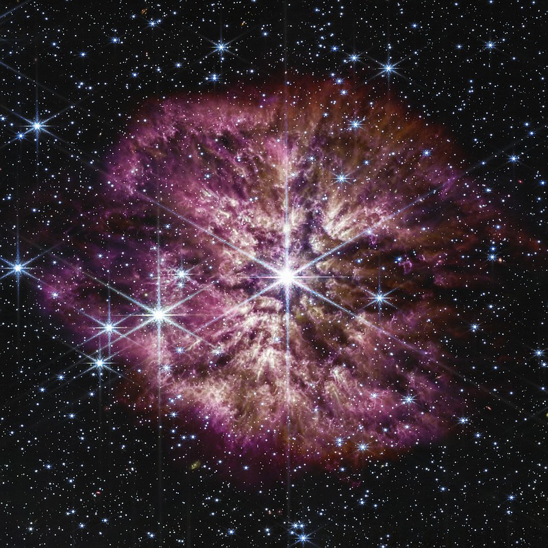 This image provided by NASA shows the star Wolf-Rayet 124, center, captured by the James Webb Space Telescope in June 2022. A surrounding nebula is made of material cast off from the aging star in random ejections, and from dust produced in the ensuing turbulence. The telescope captured the rare and fleeting phase of the star on the cusp of death. (NASA, ESA, CSA, STScI, Webb ERO Production Team via AP)