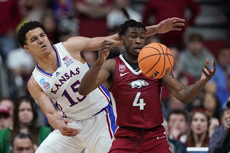 Arkansas guard Davonte Davis (4) is fouled by Kansas guard Kevin McCullar Jr. (15) in the NCAA Tournament Saturday in Des Moines, Iowa. - Photo by Charlie Neibergall of The Associated Press