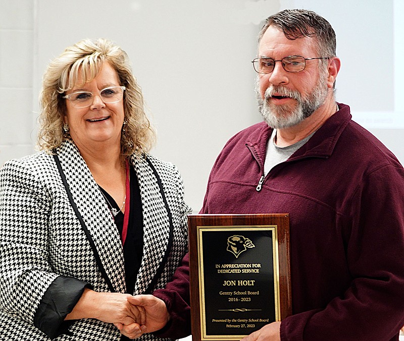 Randy Moll/Westside Eagle Observer
Jon Holt (right) was recognized by district superintendent Terrie DePaola (left) and the Gentry School Board on March 13 with a plaque for his years of service on the board. He resigned earlier this year when a family member accepted a position of employment with the district.