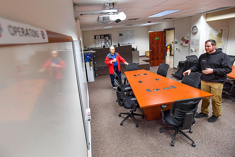 Travis Cooper (right), deputy director of the Sebastian County Department of Emergency Management, discusses features of a situation room with amateur radio operator Wayne Johnson, Friday, March 17, 2023, at the emergency operations center in Fort Smith. Visit nwaonline.com/photo for today's photo gallery.
(River Valley Democrat-Gazette/Hank Layton)