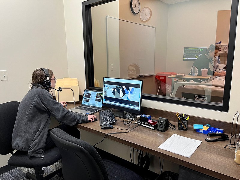 Riley Maxfield operates a patient simulation manikin from an operating room at Harding University's new nursing facility in Rogers. (NWA Democrat-Gazette/Garrett Moore)