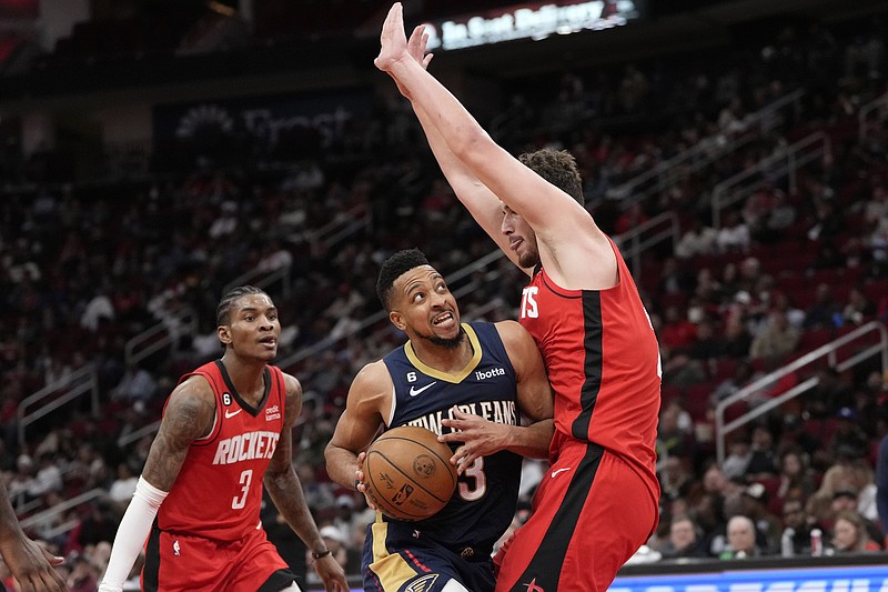 New Orleans Pelicans' CJ McCollum (3) drives to the basket as Houston Rockets' Alperen Sengun, right, defends during the second half of an NBA basketball game Sunday, March 19, 2023, in Houston. The Pelicans won 117-107. (AP Photo/David J. Phillip)