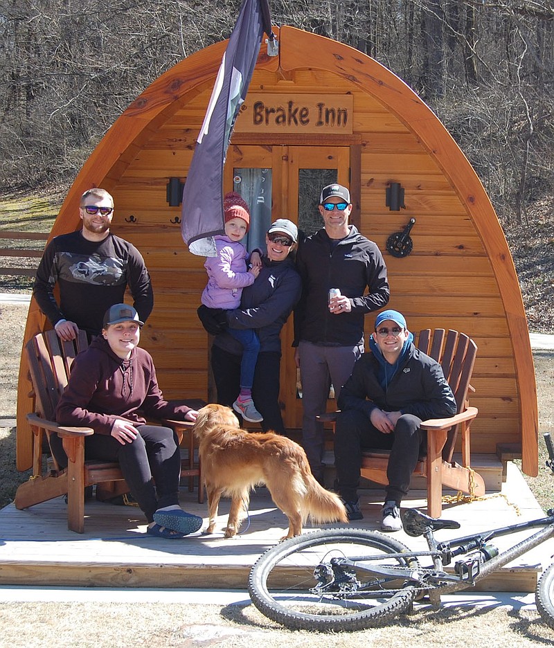 Bennett Horne/The Weekly Vista Before heading home to Kansas City, these frequent visitors to Blowing Springs Park gathered for a group photo on Sunday in front of one of the Tiny Cabins some of them occupied while staying at the park. Members of the group are (seated, from left) Esther Mengarelli, Logan Arnold, (back, from left) Will Mengarelli, Brooklyn Anderson, Kristen Anderson, Kenny Anderson and Cruz the dog.
