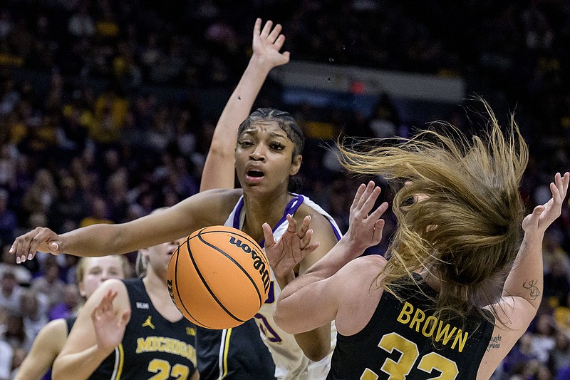 LSU forward Angel Reese, center, works against Michigan forward Emily Kiser, arm behind Reese, and Michigan guard Leigha Brown, right, for a rebound during the first half of a second-round college basketball game in the women's NCAA Tournament in Baton Rouge, La., Sunday, March 19, 2023. (AP Photo/Matthew Hinton)