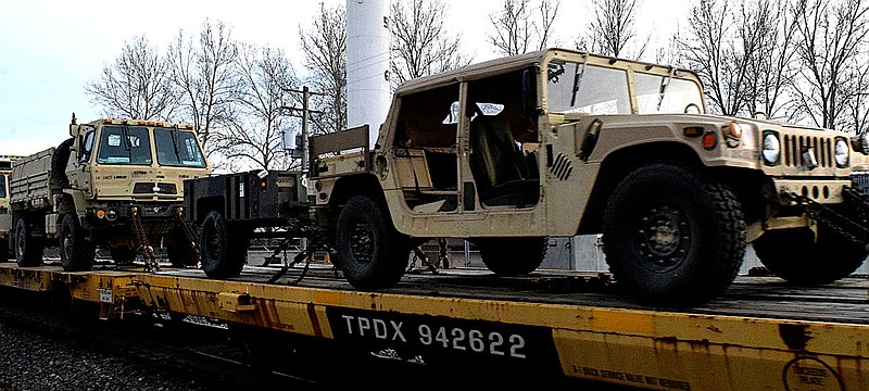 Mike Eckels/Special to the Eagle Observer
An M-998 HMMWV (Humvee), trailer and medium tactical vehicle moves through Decatur onboard a northbound Kansas City Southern military transport cargo train on March 13. The nearly 100-flatcar convoy was moving an entire Army company to an unknown location.