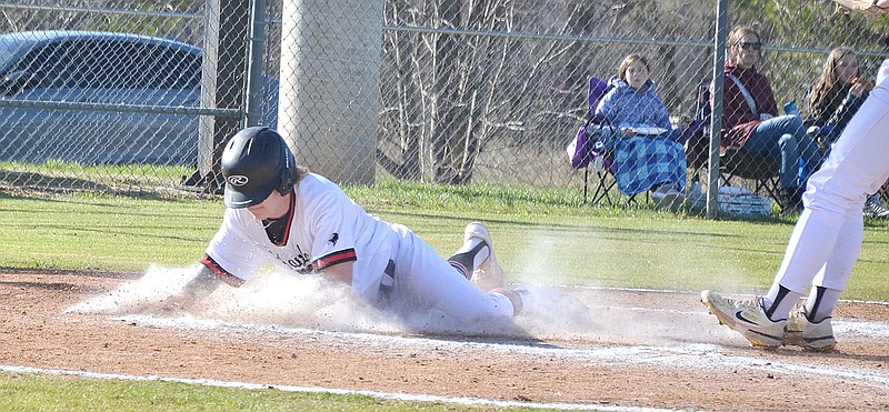 Annette Beard/Pea Ridge TIMES
Blackhawk Carson Rockhold, No. 21, slides across home plate. The Pea Ridge Blackhawks hosted the Northwest Arkansas Hornets Tuesday, March 14 and defeated them 14-0.