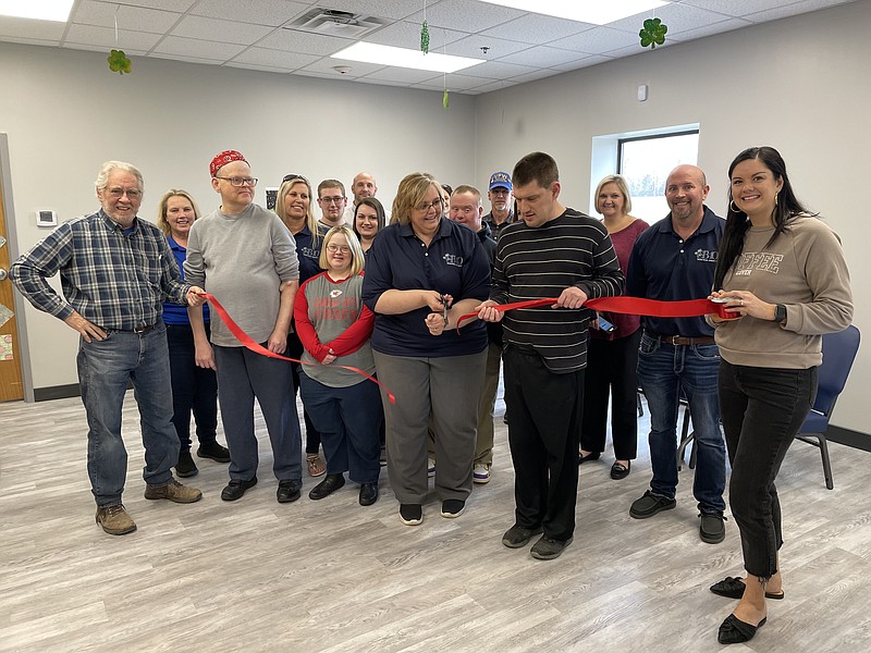 Democrat photo/Kaden Quinn
Moniteau County SB40 Executive Director Tina Benton stands with Chamber members and SB40 clients as she cuts the ribbon to her location's latest expansion.