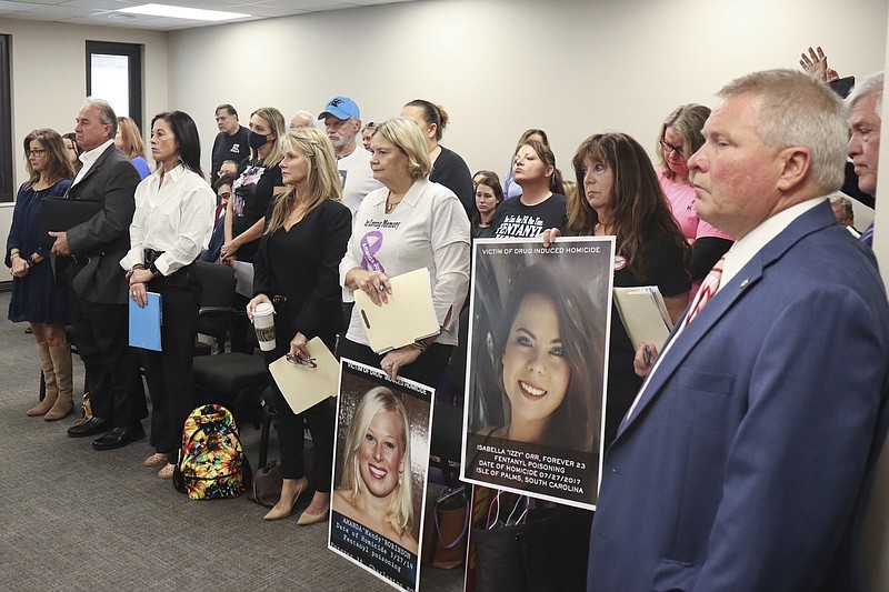 People whose family members have died from fentanyl overdose stand at a committee meeting on Jan. 19, 2023, in Columbia, S.C. With U.S. overdose fatalities at an all-time high, state legislatures are considering tougher penalties for possession of fentanyl, the powerful opioid linked to most of the deaths. (AP Photo/James Pollard)