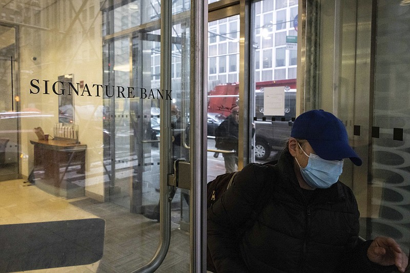 A person leaves one of the Signature Bank branches March 13, 2023, in New York. President Joe Biden is telling Americans that the nation’s financial systems are sound. This comes after the swift and stunning collapse of two banks that prompted fears of a broader upheaval. (AP Photo/Yuki Iwamura)