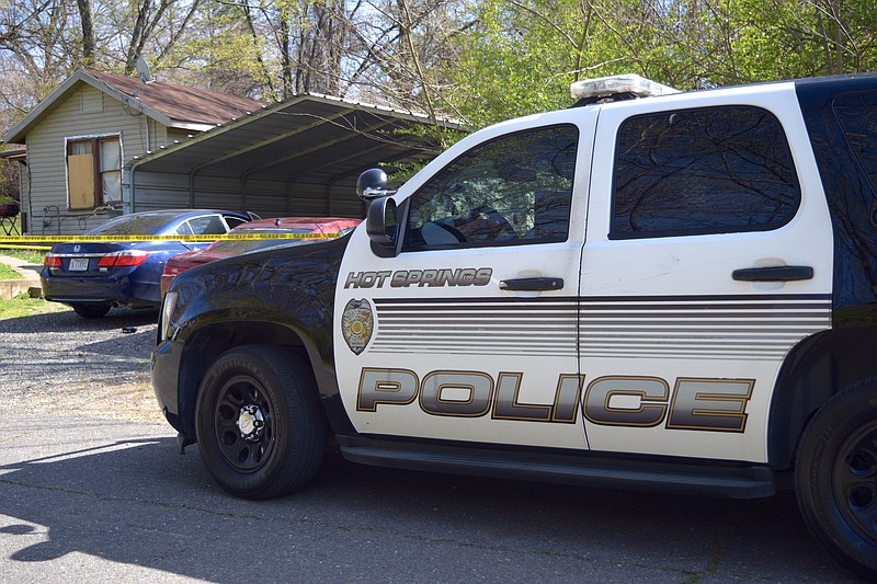 An HSPD patrol unit is shown outside a residence in the 600 block of Laser that was cordoned off by police line tape. - Photo by Donald Cross of The Sentinel-Record
