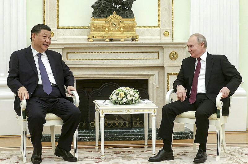 Russian Presidential Press Office via AP
In this handout photo released by Russian Presidential Press Office, Russian President Vladimir Putin, right, and Chinese President Xi Jinping talk to each other during their meeting at the Kremlin in Moscow, Russia, on Monday.