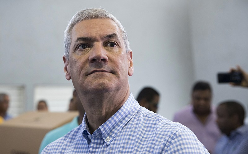 FILE - Presidential primary candidate Gonzalo Castillo, of with the Partido de la Liberacion Dominicana political party, arrives to vote during primary elections in Santo Domingo, Dominican Republic, Oct. 6, 2019. Authorities in the Dominican Republic have arrested 19 people in a sweeping corruption investigation that targeted Castillo and three ex government officials accused of illegal campaign financing.  (AP Photo/Tatiana Fernandez, File)