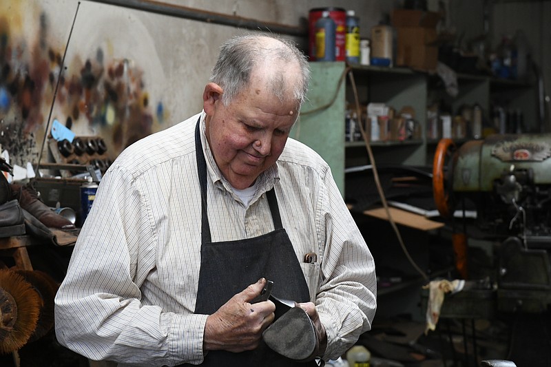 David Garner fixes a high heel Tuesday. He will accept new shoe repair jobs until the end of March before finishing the remainder of his work at John's Shoe Hospital. - Photo by Lance Brownfield of The Sentinel-Record