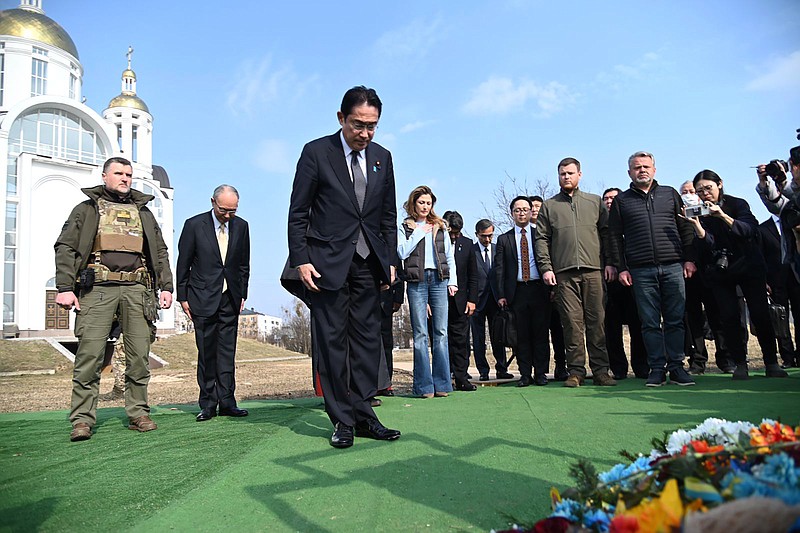 Japanese Prime Minister Fumio Kishida, centre, offers prayers, at a church in Bucha, a town outside Kyiv that became a symbol of Russian atrocities against civilians, in Ukraine, Tuesday, March 21, 2023. (Ukrainian Foreign Ministry Press Office via AP)