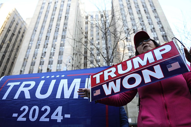 Stephanie Lu, of New York, stands in front of the New York Criminal Courts building criticizing New York County District Attorney Alvin Bragg and a possible criminal indictment of former President Donald Trump, on Monday, March 20, 2023, in New York. (AP Photo/Bryan Woolston)