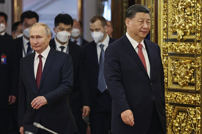 Russian President Vladimir Putin, left, and Chinese President Xi Jinping enter a hall for their talks at The Grand Kremlin Palace, in Moscow, Russia, Tuesday, March 21, 2023. (Mikhail Tereshchenko, Sputnik, Kremlin Pool Photo via AP)