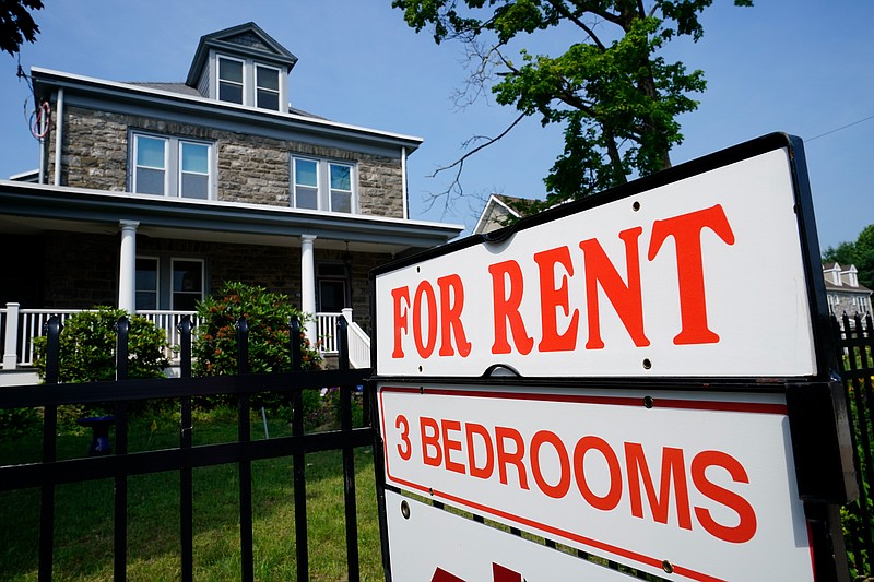 FILE - A sign indicating the availability of a home to rent stands outside a building in Philadelphia, Wednesday, June 22, 2022.  House flipping, &#x201c;house hacking&#x201d; and vacation rentals have skyrocketed in popularity in recent years, becoming a distinctly millennial way of generating passive income in an uncertain economy. The potential profit is tempting, but is it worth the time and money? Ongoing repairs and responsibility to tenants can make renting a major undertaking, so know your financial and personal limits before signing the dotted line.  (AP Photo/Matt Rourke, File)