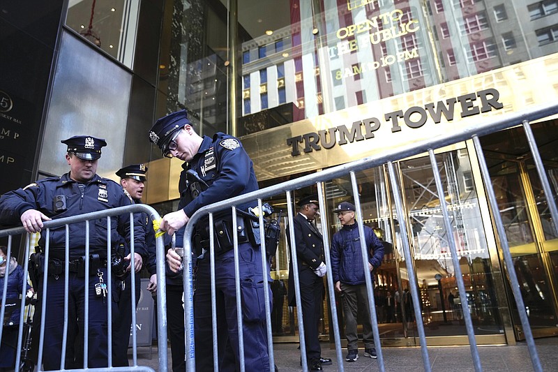 Police officers place a barricade in front of Trump Tower, on Tuesday, March 21, 2023, in New York. (AP Photo/Bryan Woolston)