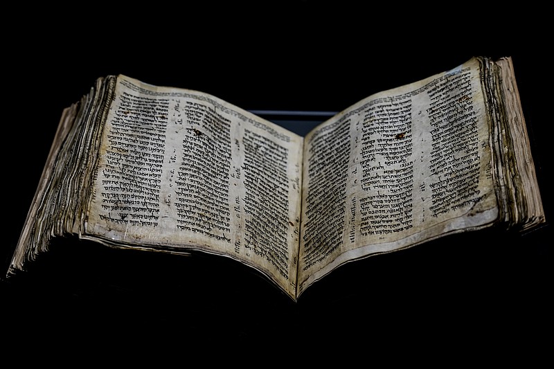 The Codex Sassoon, a 1,100-year-old Hebrew Bible, is on display Wednesday, March 22, 2023, at Tel Aviv's ANU Museum of the Jewish People for a week-long exhibition of the manuscript. The exhibition is part of a whirlwind worldwide tour of the artifact in the United Kingdom, Israel and the United States before its expected sale for $30 million to $50 million. The codex is one of the oldest surviving biblical manuscripts. (AP Photo/Ariel Schalit)