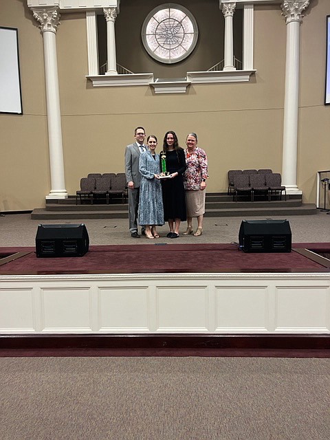 Kaitlyn Hill, from First Apostolic Church, and teammate Elyse Newman, from Jena, Louisiana, placed third at the Southcentral Region Apostolic Bible Quizzing Tournament, Experienced Division, held in Dequincy, Louisiana on Friday & Saturday, March 3 & 4. Kaitlyn placed first on the All-Tournament Team.  Pictured above are (from left) Coach Jonathan Hill, Kaitlyn, Elyse and Coach Stacy Newman. (Photo Contributed)