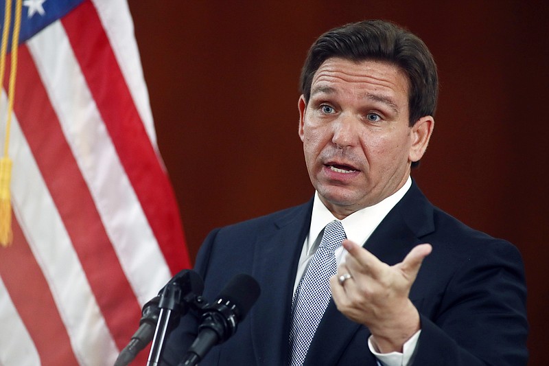 FILE - Florida Gov. Ron DeSantis answers questions from the media in the Florida Cabinet following his State of the State address during a joint session of the Senate and House of Representatives, Tuesday, March 7, 2023, at the state Capitol in Tallahassee, Fla. DeSantis' administration is moving to unilaterally forbid classroom instruction on sexual orientation and gender identity in all grades, expanding the controversial law critics call &#x201c;Don't Say Gay&#x201d; as the Republican governor continues a focus on cultural issues ahead of his expected presidential run. (AP Photo/Phil Sears, File)