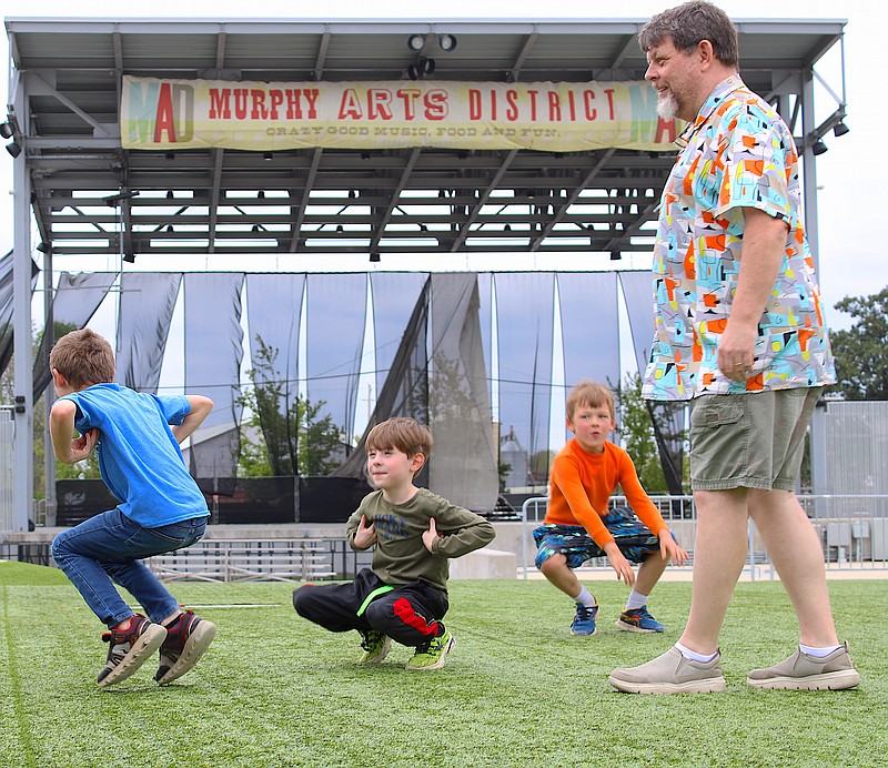 From left, Cecil Hinson, 9, Landon Graham, 7, and Beau Beckham, 6, pretend to be chimpanzees during an improvisation game at MAD. (Caitlan Butler/News-Times)