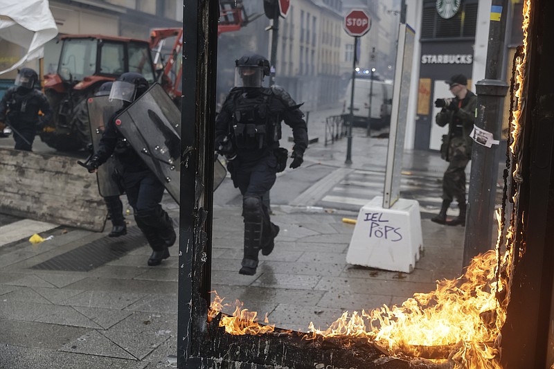Riot police scuffle with protesters during a protest in Rennes, western France, Wednesday, March 22, 2023. The bill pushed through by President Emmanuel Macron without lawmakers' approval still faces a review by the Constitutional Council before it can be signed into law. Meanwhile, oil shipments in the country were disrupted amid strikes at several refineries in western and southern France. (AP Photo/Jeremias Gonzalez)