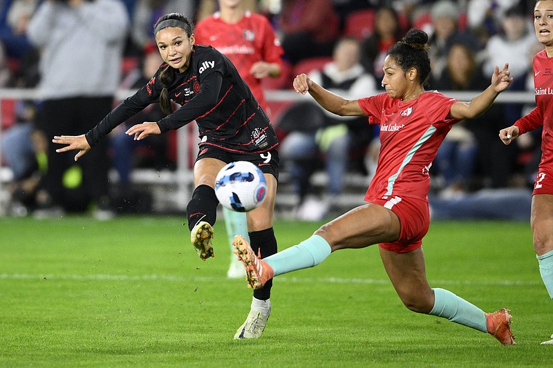 FILE - Portland Thorns FC forward Sophia Smith, left, kicks the ball against Kansas City Current defender Addisyn Merrick, right, during the first half of the NWSL championship soccer match, Saturday, Oct. 29, 2022, in Washington. Portland is also among the favorites this season because of a loaded roster that includes U.S. national team players like Sophia Smith, Crystal Dunn and Becky Sauerbrunn. (AP Photo/Nick Wass, File)
