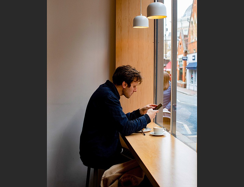 A man sits in the window at Kiss the Hippo in Richmond. Fans of Apple TV+’s “Ted Lasso” can make their own tour around the show’s settings. (Photo for The Washington Post/Elena Heatherwick)