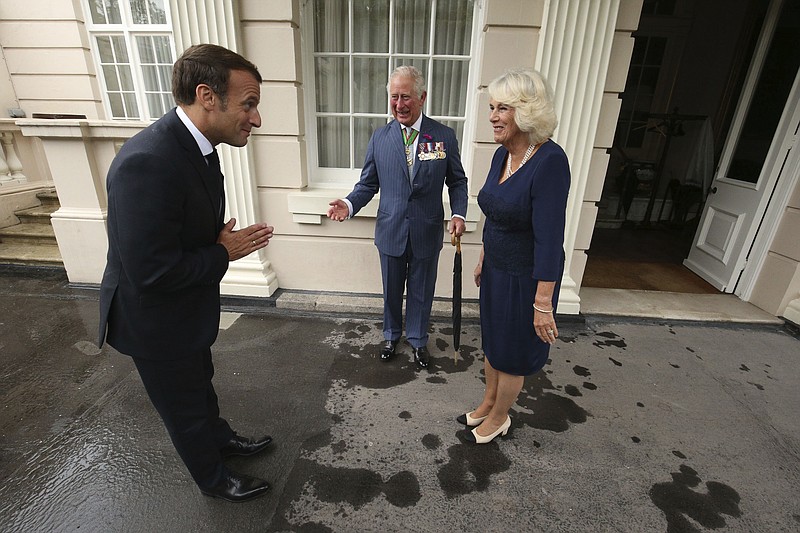 FILE - Britain's Prince Charles and Camilla, Duchess of Cornwall welcome French president Emmanuel Macron to Clarence House in London, Thursday June 18, 2020. Unrest in France is tarnishing the sheen of King Charles III’s first overseas trip as monarch. Striking workers have refused to provide red carpets and critics are calling for the British king's visit to be canceled altogether amid pension reform protests. (Jonathan Brady/Pool via AP, File)