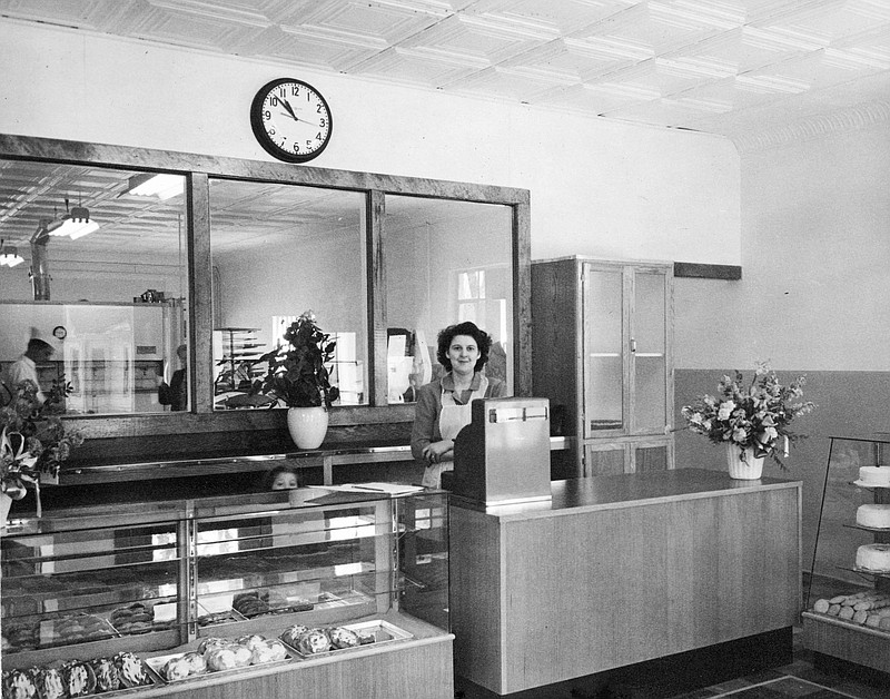 Photo courtesy the Kingdom of Callaway Historical Society
Leonard Taylor's wife Aline and daughter Marilyn (peeking over the counter to her right) in the bakery at 203 St. Louis Ave. The interior has changed, but the building still stands across from Little Caesar's Pizza.
