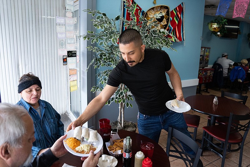 Victor Hernandez Jr. serves lunch customers at his restaurant, Taqueria El Molcajete, in Belvidere, Ill., on March 11, 2023. MUST CREDIT: Photo for The Washington Post by Kayla Wolf