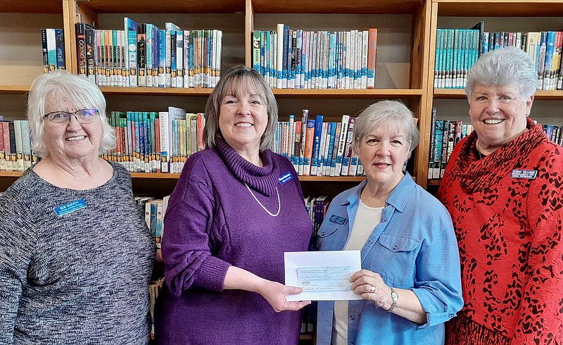 Submitted photo
Karen Benson (second from left), Gravette Public Library director, accepts a $500 check from members of the Bentonville/Bella Vista Chapter of Altrusa International Thursday, March 23. The donation will be used for the library's 2023 summer reading program. Pictured with Benson are Altrusa members Sue McEvoy, Gay Kiker and Donna Williams.