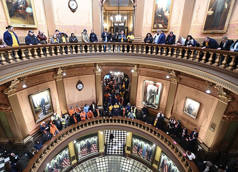 FILE - Union members and supporters chant in the Capitol rotunda, Tuesday morning, March 14, 2023, as they wait for a Right To Work bill to be voted on.  Michigan, long known as a mainstay of organized labor, became the first state in decades to repeal a union-restricting law known as “right-to-work” that was passed over a decade ago by a Republican-controlled Legislature. (Todd McInturf/Detroit News via AP)