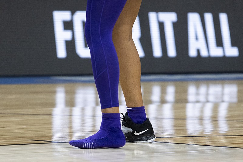 LSU's Angel Reese plays without one of her shoes during the second half of the team's Sweet 16 college basketball game against Utah in the women's NCAA Tournament in Greenville, S.C., Friday, March 24, 2023. (AP Photo/Mic Smith)