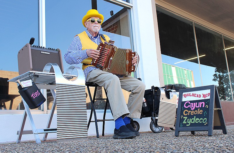 Railhead Ned watches the crowd as he squeezes out zydeco tunes on a Cajun accordion outside Crossties Event Venue during the annual Home & Garden Show on Saturday, March 25, 2023, in downtown Texarkana, Ark. Ned took up the accordion about 11 years ago after retiring from his construction business. He said he frequently busks downtown along Broad Street. (Staff photo by Stevon Gamble)