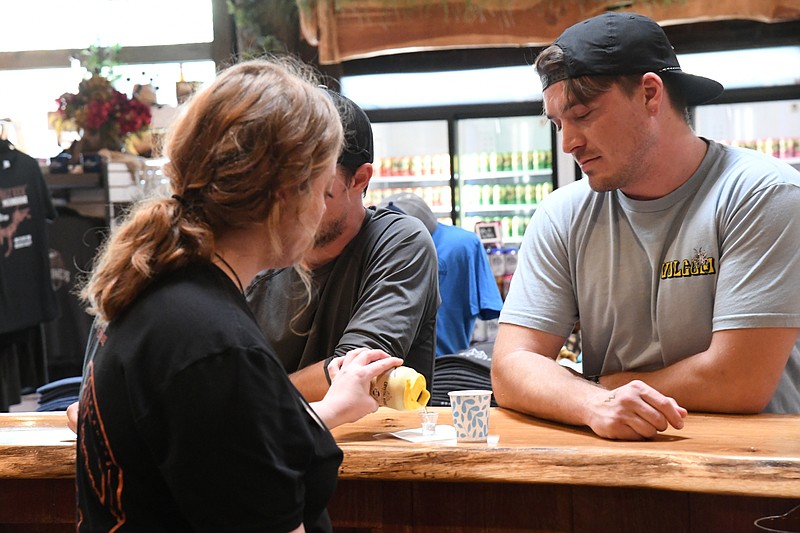 Customers enjoy a free tasting at Crystal Ridge's third anniversary celebration Saturday. - Photo by Lance Brownfield of The Sentinel-Record.