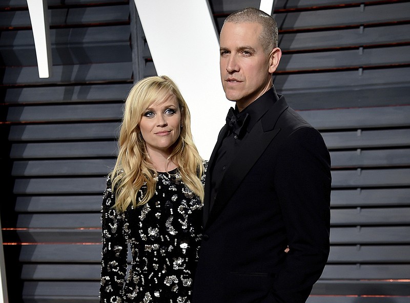 FILE - Reese Witherspoon and Jim Toth appear at the Vanity Fair Oscar Party in Beverly Hills, Calif. on Feb. 27, 2017.  Witherspoon and her husband, Hollywood agent Jim Toth, have announced they are divorcing after nearly 12 years of marriage. (Photo by Evan Agostini/Invision/AP, File)