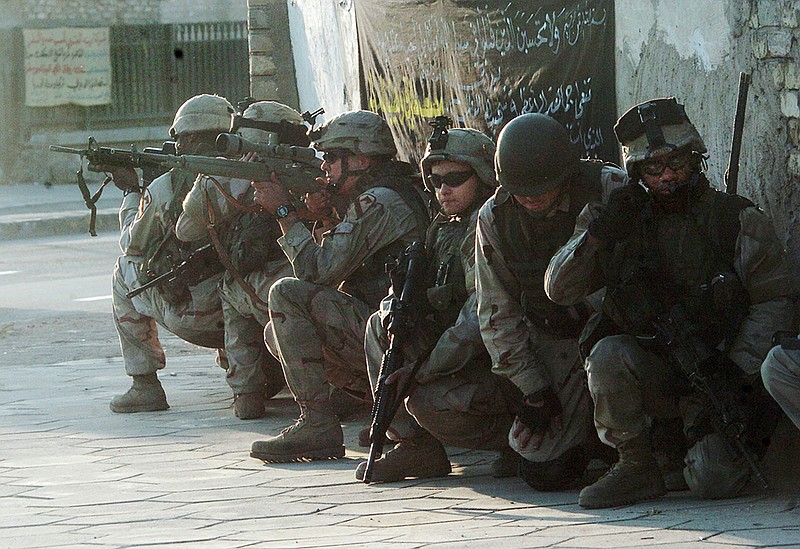 Arkansas Democrat-Gazette/MICHAEL WOODS

Members of Charlie Company third battallion take cover just before the EOD detonates an ied in the adhamyiah district of Baghdad Saturday afternoon.

11/20/04