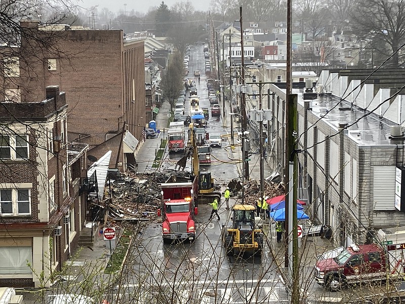 Emergency responders and heavy equipment are seen at the site of a deadly explosion at a chocolate factory Saturday, March 25, 2023, in West Reading, Pa. (AP Photo/Michael Rubinkam)