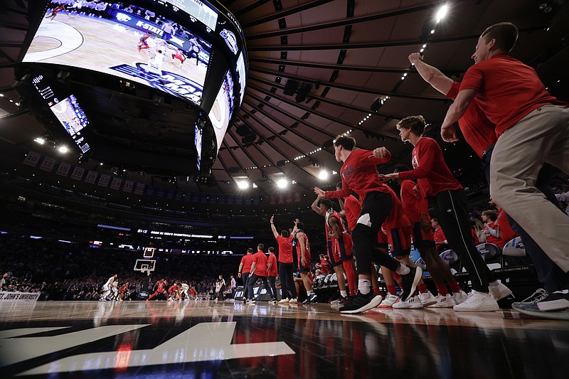 Florida Atlantic players celebrate after defeating Kansas State 79-76 in the Elite 8 Saturday in New York. - Photo by Adam Hunger of The Associated Press