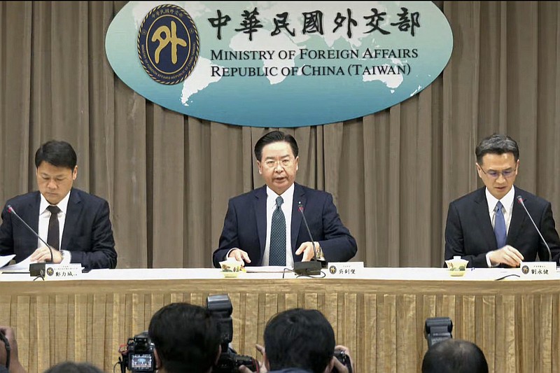 In this image from video released by Taiwan Ministry of Foreign Affairs Office, Taiwan Foreign Minister Joseph Wu, center, prepares to speak at a press conference after Honduras announced severance of diplomatic ties with Taiwan, in Taipei, Taiwan, Sunday, March 26, 2023. Honduras has cut diplomatic ties with Taiwan, the Latin American country announced Saturday, saying it recognizes "only one China in the world." (Taiwan Ministry of Foreign Affairs via AP)