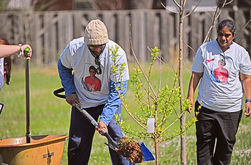 Pavan Roy Marupally and his wife, Sridevi Eadara, parents of Tanvi Marupally, plant a tree in honor of Tanvi’s birthday Sunday, March 26, 2023 in the community garden behind the Faulkner County Library in Conway.
(Arkansas Democrat-Gazette/Staci Vandagriff)