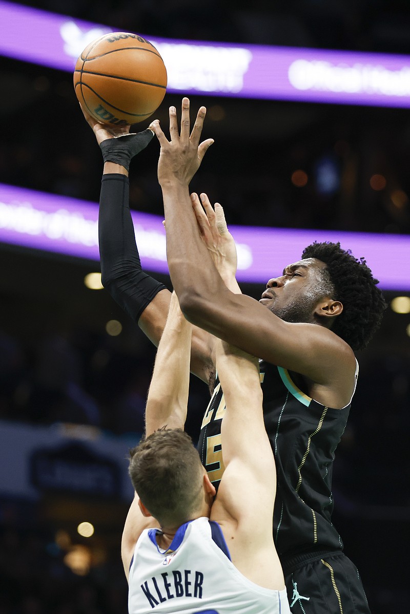 Charlotte Hornets center Mark Williams, right, shoots over Dallas Mavericks forward Maxi Kleber during the first half of an NBA basketball game in Charlotte, N.C., Sunday, March 26, 2023. (AP Photo/Nell Redmond)