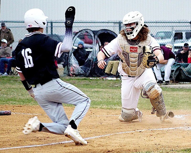 Randy Moll/Westside Eagle Observer
Siloam Springs' Bode Butler slides across home plate ahead of the throw to Gentry catcher Crafton Beeler during play between the Panthers and the Pioneers in Gentry on Feb. 21.