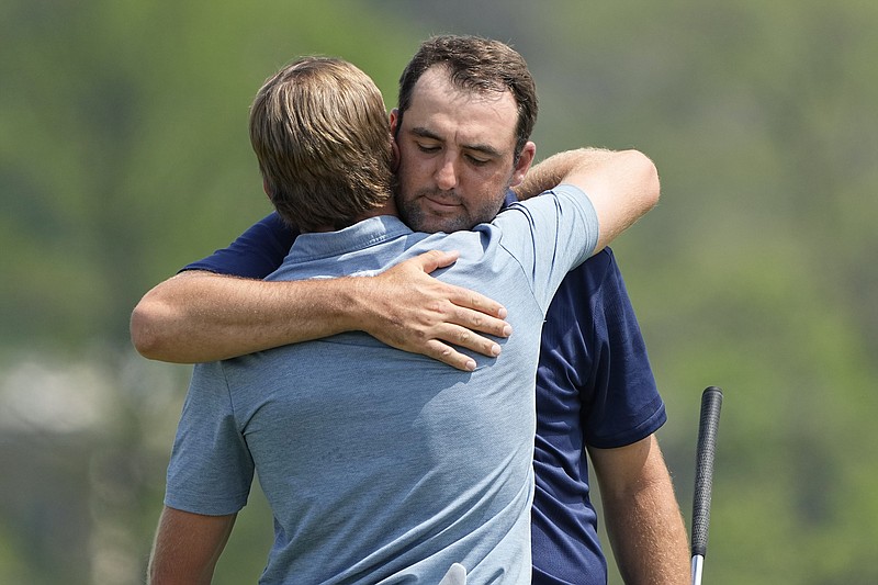 Scottie Scheffler, right, hugs Sam Burns, left, after their semifinal round at the Dell Technologies Match Play Championship golf tournament in Austin, Texas, Sunday, March 26, 2023. Burns defeated the Scheffler, the defending champion, win in a playoff. (AP Photo/Eric Gay)