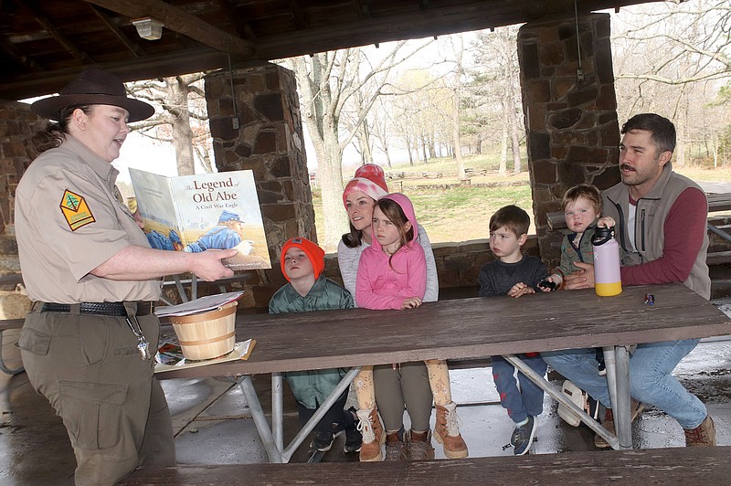 Lynn Kutter/Enterprise-Leader
Mattison Griffin, interpreter at Prairie Grove Battlefield State Park, reads the book "The Legend of Old Abe" to the Tomaszewski family from Benton: Aaron, Mikayla and their children, Forrest, Oliver, Piper and Ellis. The state park had lots of activities for families during spring break. For this activity, Griffin was talking about animals used during the Civil War. Old Abe was an eagle used at the Battle of Corinth.
