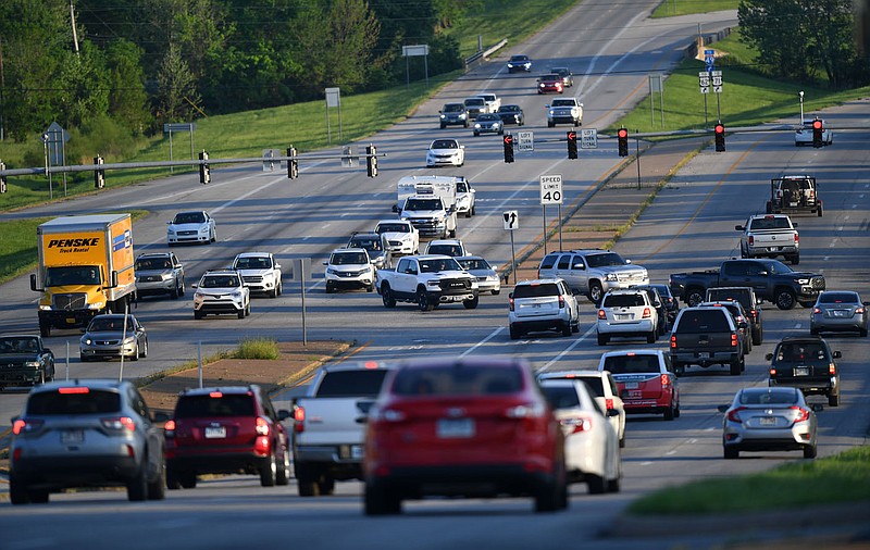 Traffic moves Thursday, May 12, 2022, through the intersection of Joyce Boulevard and College Avenue in Fayetteville. Regional Planners got their first look last week at a draft of a new traffic congestion management process for the Northwest Arkansas metro area. The study provides a basic assessment of traffic conditions and lays the groundwork for developing strategies to ease congestion on the region's major roadways. Visit nwaonline.com/220515Daily/ for today's photo gallery. 
(NWA Democrat-Gazette/Andy Shupe)