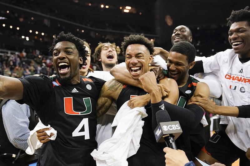 Miami celebrates after their win against Texas in an Elite 8 college basketball game in the Midwest Regional of the NCAA Tournament Sunday, in Kansas City, Mo. - Photo by Jeff Roberson of The Associated Press